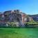 People swimming next to a cliff in Lake Vouliagmeni in Athens, Greece